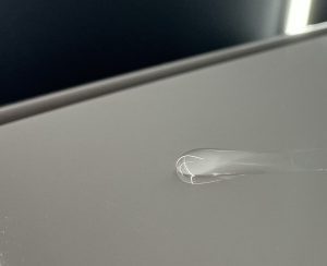 “Water droplets on a white car bonnet, showing hydrophobic effect from polishing on the Gold Coast.”